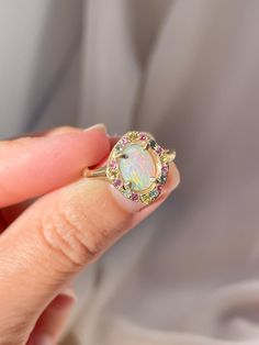 One of a kind 14k Yellow Gold Australian Opal Ring, enraptured by a dreamy pastel halo of Aquamarine, Pink Sapphires and Yellow Sapphires. 💌 Please write desired size (between 4-8) in *Notes* section at checkout Opal enhances cosmic consciousness and imparts mystical visions. Acting as a mirror, it reflects your thoughts and feelings back to you while shielding you as a karmic protector to deflect empathic emotions that are shone onto you by others. Opal is a teacher - amplifying our emotions s Multicolor Halo Ring As Gift, Multicolor Halo Rings As A Gift, Multicolor Halo Rings For Gift, Multicolor Halo Rings Fine Jewelry, Multicolor Oval Jewelry With Halo Setting, Oval Multicolor Jewelry With Halo Setting, Multicolor Jewelry With Halo Setting For Wedding, Multicolor Halo Setting Jewelry For Wedding, Multicolor Halo Jewelry For Wedding