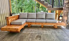 a couch sitting on top of a wooden floor next to a stair case in a house