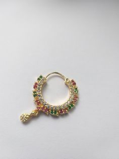 a gold ring with multicolored stones on it