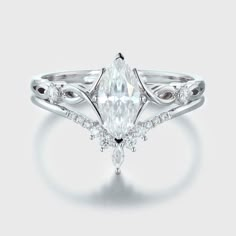 a white gold ring with a pear shaped diamond