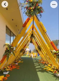 an arch made out of yellow and orange flowers