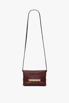 A sophisticated day-to-night option, the Mini Chain Pouch in Burgundy is crafted from supple leather with a sumptuous suede lining. It has a detachable strap for versatile styling as either a shoulder bag or clutch., while the house’s signature gold-tone chain detail adds a striking finishing touch. Victoria Beckham Mini Chain Pouch Bag With Long Strap In Burgundy Leather  - Size Default Title UK Leather Clutch For Everyday Luxury, Elegant Leather Clutch With Chain Strap, Elegant Leather Clutch With Chain Detail, Elegant Leather Clutch With Chain, Rectangular Leather Evening Bag With Chain Strap, Leather Crossbody Evening Bag With Metal Hardware, Everyday Luxury Clutch With Chain Strap, Leather Clutch With Chain Strap, Chic Leather Clutch With Metal Hardware