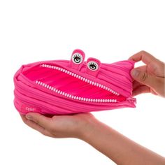 Brighten your day with ZIPIT's playful pencil case, designed to add a touch of fun to your daily routine. Featuring bright eyes and a toothy grin, this unique pencil pouch is made from one long zipper, making it as clever as it is charming. The spacious interior provides plenty of room for all your essentials, keeping you organized in a whimsical way. With its big personality and practical design, the ZIPIT Monster Pouch is perfect for storing a variety of items. The extra-wide opening ensures y Pink Pencil-shaped Case With Zipper Closure, Pink Pencil-shaped Pencil Case With Zipper, Pink Pencil Case With Zipper Pocket For Personal Use, Playful Pink Portable Pencil Case, Cute Pink Pencil Case With Zipper Closure, Fun Pink Pencil Case For School, Playful Pink Pencil Case With Pen Slots, Kawaii Pencil Case With Zipper Closure, Pink Playful Pouch Pencil Case