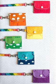 four colorful wallets hanging on a wall