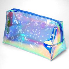 Carry your makeup and other essentials in style! Holographic, graffiti makeup bag provides ample space for travel and everyday. Closure: Zipper Dimensions: 8'' W x 5'' H Material: PU - Claire's Medium Holographic Graffiti Makeup Case - Blue Trendy Rectangular Cosmetic Bag, Trendy Zipper Pouch For School Cosmetic Storage, Trendy Zipper Pouch For School, Trendy Blue Rectangular Case Bag, Trendy Multicolor Portable Cosmetic Bag, Trendy Blue Rectangular Cosmetic Bag, Trendy Blue Rectangular Pouch, Trendy Blue Cosmetic Bag For Travel, Trendy Blue Travel Cosmetic Bag