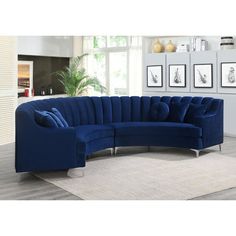 a large blue sectional couch sitting on top of a white rug