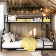 a bunk bed in a room with wood paneling and lights on the wall above it