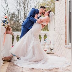 a bride and groom kissing on the porch