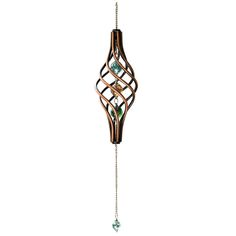 a wind chime hanging from the side of a white wall with green glass beads