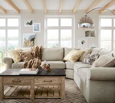 a living room filled with furniture and windows