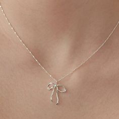 Sterling Silver Bow Necklace, Sparkling Crystal Bow Charm Necklace, Bow Jewelry, Silver Necklace, Perfect Gift for Her (NZ2182) ▶ Product Info. - Material: 925 Sterling Silver / Cubic Zirconia - Metal Finish: 14K Gold / Silver + Anti-Tarnish E-Coat  - Safety: Nickle & Lead free and Hypoallergenic - Dimensions: Pendant - 17.4mm x 21mm w/width 3.2mm / Cubic Zirconia - 3.5mm - Length: 40cm + 3.5cm (length adjustable) - Weight: 3g - TATIANA & Silver 925 engraved tag was added. - Made In South Korea Girly Jewelry Silver, Mother's Day Party Sterling Silver Necklace, Elegant Round Pendant Necklaces As Gift, Silver Necklaces For Mother's Day Party, Elegant Round Pendant Necklaces For Gifts, Elegant Pendant Charm Necklaces, Elegant Charm Necklaces With Clavicle Chain As Gift, Sterling Silver Clavicle Chain Necklace Suitable For Gifting, Elegant Handmade Silver Charm Necklaces