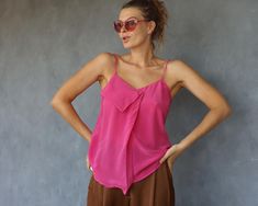 Vintage pink pure silk tiny strap blouse top. Front pleat, no lining. Material feels like pure silk. No tags. Will fit sizes XS-S best. Measured laying flat (please double for circumference): 24'' / 61 cm long 17'' / 43 cm armpit to armpit Few minor marks. Very good vintage condition. Pink Sleeveless Blouse Camisole For Spring, Silk Sleeveless Camisole For Summer, Silk Sleeveless Blouse Camisole For Summer, Elegant Pink Tank Top For Summer, Pink Summer Camisole Blouse, Summer Pink Camisole Blouse, Pink Camisole Blouse For Summer, Chic Pink Spaghetti Strap Tank Top, Chic Pink Tank Top With Spaghetti Straps