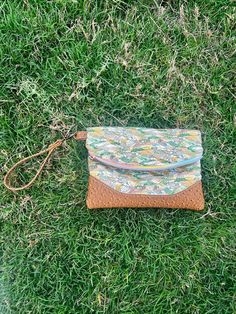 This versatile foldover clutch (Heidi by Swoon Patterns) has one exterior zip pocket on the back, in addition to the main zippered pocket. There is an attached vinyl strap for your wrist or just use the bag as a clutch. The exterior features a painted landscape print (reminds me of Van Gogh's style) with brown faux ostrich vinyl accents and cream and tan cotton lining. The front zipper shows off a rose gold butterfly pull and on the back is a rose gold star pull. The bag has a double closure, which includes a zip and a magnetic snap to keep the bag folded. Approximate dimensions: 8.5" W x 6.5" H (closed)/ 10.5" H (open) Travel Envelope Clutch With Removable Pouch, Travel Clutch Bag With Flat Pocket, Zipper Closure Pouch Clutch, Multicolor Clutch With Cell Phone Pocket For Everyday Use, Handheld Clutch With Zipper For Travel, Handheld Travel Clutch With Zipper Pouch, Travel Wristlet With Zipper Closure In Pouch Shape, Crossbody Wristlet With Zipper For Travel, Everyday Clutch Wristlet With Detachable Strap