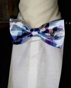 "Stunning and classic bow tie has been design in exotic, bright satin prints. The Unisex bow ties are an excellent evening addition to any wardrobe. You will look unique at any special occasion. Our bow ties are made in fine satin with interfacing to give it, stability and shape. Approximate Measurements: Bow: 5\" x 2.5\" Adjustable Strap: 14\" x 19\" Bow Tie care recommended Dry Clean only. All items are sent Via USPS First Class Mail within the U.S. shipping times take an average of 5-7 Busine Fitted Purple Suit And Tie Accessories For Party, Purple Fitted Suit And Tie Accessories For Groom, Fitted Purple Tie For Groom, Purple Bow Tie For Party, Purple Party Bow Tie, Elegant Fitted Multicolor Bow Tie, Fitted Satin Bow Tie For Summer, Spring Wedding Bow Ties, Blue Bow Tie For Summer Weddings