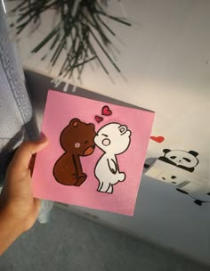 someone holding up a card with a bear and panda on it