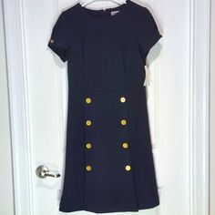 Brand: Shelby And Palmer Item Type/Name: Mini Dress Size: 12 Color: Dark Navy Blue Condition: Great Condition Material: 96% Polyester, 4% Spandex Features: Golden Button Accents, Two Slits Up The Front Care Instructions: Wash In Cold Water And Tumble Dry On Low Keywords: Nautical, Formal, Nature, Preppy, Geek, Business Casual, Office, Church, Coastal Grandma, Beach, Sailing, Classic Thank You For Checking Out My Clothes! Please Leave A Comment If You Have Any Inquiries! Classic Career Dresses With Buttons, Spring Career Dresses With Buttons, Career Dresses With Buttons For Spring, Knee-length Career Dresses With Button Closure, Fitted Navy Dress With Buttons, Classic Navy Dress With Button Closure, Navy Formal Dress With Button Closure, Formal Navy Dress With Button Closure, Classic Navy Dress With Buttons