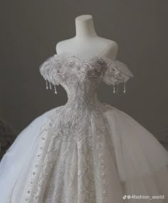 a white wedding dress with beading on it