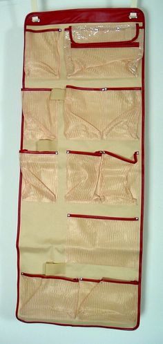 a red and beige hanging organizer on a white wall