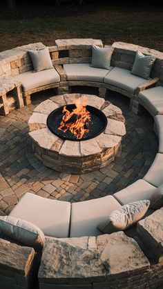 an outdoor fire pit with seating around it