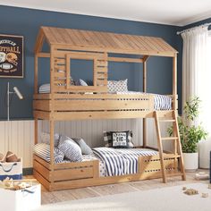 a wooden bunk bed sitting next to a blue wall