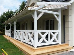 a white house with a porch and covered patio