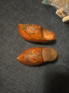 two wooden shoes that have been decorated with flowers