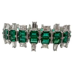 Rare matching emerald and diamond bracelet in 18KT whte gold. The bracelet is made in Art Deco style, creator is known. The matching emeralds are Colombian origin and are a beautiful bluish green color, the bracelet is made with a rare exquisite craftsmanship and excellent matching stones! Metal Type: 18KT Gram Weight:34.39 grams Natural Emerald(s): Color: Bluish Green Cut:Emerald Carat: 23.90ct Clarity: Slightly Included Origin: Colombia Natural Diamond(s): Color: F-G Cut:Round Brilliant, Emera Emerald Art Deco, Emerald Art, Bracelet Tennis, Art Deco Bracelet, Colombian Emeralds, Estilo Art Deco, Bluish Green, Natural Emerald, Art Deco Style