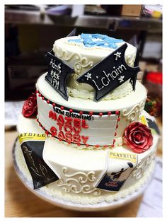 a three tiered cake is decorated with books