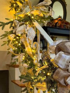 a christmas wreath with lights on the stairs