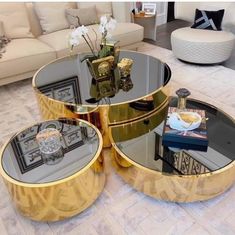 three tables sitting on top of each other in front of a couch and coffee table