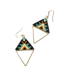 These earrings were hand woven using a brass triangle frame and glass seed beads to create a tribal pattern. Each earring is 2.5 inches long.  These earrings hang from 14k gold filled ear wires. Beaded Triangle Earrings, Triangle Frame, Seed Bead Jewelry Patterns, Earrings Patterns, Beaded Earrings Patterns, Loop Earrings, Triangle Pattern, Triangle Earrings, Earring Patterns