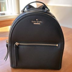 Kate Spade Black Pebbled Leather Backpack - Gold Zippers, Buckles, And Logo - Adjustable Straps - One Interior Pocket - Black Fabric Lining - 8.5” Across, 10” Tall, 4” Deep - Never Used, Like New Condition Kate Spade Versatile Bag With Zipper, Kate Spade Everyday Backpack With Zipper, Everyday Kate Spade Backpack With Zipper Closure, Versatile Kate Spade Bag With Zipper, Elegant Kate Spade Backpack With Zipper Closure, Kate Spade Black Backpack With Removable Pouch, Kate Spade Black Backpack For On-the-go, Kate Spade Black Everyday Backpack, Kate Spade Backpack With Adjustable Strap For Everyday Use