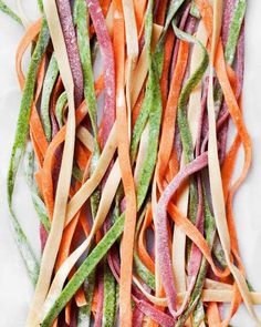 several strips of colorful vegetables on a white surface