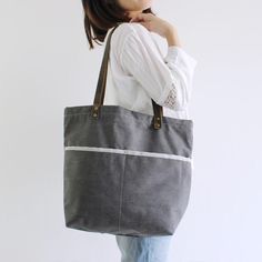 Handmade Canvas Tote Bag, Shoulder Bag With Leather Handle, School Bag Model Number: 14043 Dimensions: 15.7"L x 4.7"W x 17.7"H / 40cm(L) x 12cm(W) x 45cm(H) Weight: 3.09 lb / 1.4 kg Material: Waxed Canvas And Full Grain Leather Color: Gray Features: • Long Handle Drop • YKK Zipper • Cotton Lining • Inside zipper pocket, Laptop sleeve, Can fit 14" laptop, 1 cell pocket, 1 wallet pocket School Purse, Laptop Handbag, Grey Tote, Leather Duffle Bag, Badass Style, Purse Vintage, Bag School, Leather Duffle, Monogram Tote