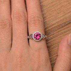 It is a pretty lab ruby ring, the round cut ruby is about 7mm*7mm, weight about 1.66 carats. The basic metal is sterling silver and plated with rhodium. To change the metal to a solid gold (white/rose) or platinum is also available, please ask for a quotation if you want. You can also go to my shop Home for more elegant rings: https://www.etsy.com/shop/godjewelry?ref=hdr_shop_menu Ruby is the birthstone of July, it will be a great gift for your lover! More ruby rings: https://www.etsy.com/shop/g Ruby Ring Engagement, Rubin Ring, Round Cut Ring, Red Gemstone Ring, Ruby Engagement Ring, Red Gemstones, Halo Engagement Rings, July Birthstone, Elegant Ring