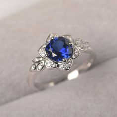 ◆The ring draws inspiration from the polaris. Hand-finished in Sterling sliver, this piece features a round shaped sapphire. Clear zirzons decorate around the main stone. An extremely simple celestial ring that you cannot miss. ◆ Production Description: Main stone Type: Lab Sapphire Main Stone Shape: Round Main Stone Size:7*7mm(1.66ct) Side stone: CZ Metal: 925 Sterling silver - Other options available in the drop down menu ◆ Customization: √Free for Add Engraving √Other Metal Type Available √Ot Leaves Engagement Ring, Rings Sapphire, Oval Sapphire Ring, Celestial Ring, Gold Flower Ring, Leaf Engagement Ring, Minimalist Engagement Ring, Classy Tattoos, London Blue Topaz Ring