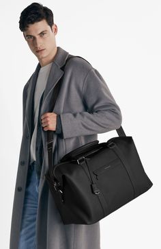 A lightweight all-leather companion overflowing with dynamic storage and multifaceted carriage for first class journeys. Inspired by thousands of miles transiting between airports, The Duffle features an expandable silhouette for enhanced visibility and effortless retrieval of your belongings, convertible trolley sleeve to carry atop luggage, dedicated phone, passport and laptop pockets, a detachable jacquard strap and slides perfectly into every overhead compartment. A thoughtful travel sidekic Luxury Black Travel Accessories For On-the-go, Luxury Duffle Bag With Detachable Strap For Business Trips, Black Leather Luggage, Luxury Travel Bag With Detachable Strap For Business Trips, Luxury Business Travel Bag With Detachable Strap, Elegant Black Duffle Bag For Formal Occasions, Elegant Black Formal Duffle Bag, Elegant Leather-trim Luggage For Business Trips, Modern Travel Bag With Leather Trim