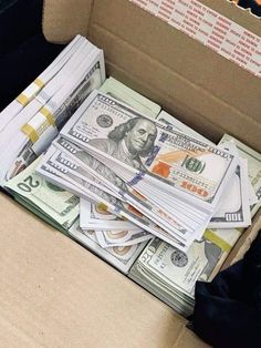 a cardboard box filled with lots of money