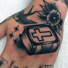 a person's hand with a tattoo on it and an object in the middle