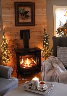 a living room filled with furniture and a fire place in the middle of christmas decorations