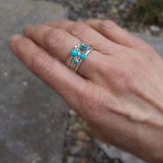 "Turquoise and silver stacking rings created from recycled silver and four different turquoise gemstones. For the largest stone you can choose to either have one with lovely matrix (first picture) or solid color (fifth picture). The others are different complimentary shades of solid blue. The rings coordinate beautifully giving you many options. Artfully simple if worn alone, they can be worn with other stacking rings for a pop of color. Also, available with oxidized finish (last 2 pictures). If Blue Turquoise Stackable Open Ring, Unique Stackable Turquoise Jewelry, Unique Turquoise Stackable Jewelry, Blue Turquoise Stackable Round Ring, Stackable Round Turquoise Ring In Blue, Stackable Blue Turquoise Ring In Sterling Silver, Unique Stackable Blue Rings, Unique Blue Stackable Round Rings, Unique Blue Stackable Rings