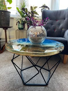 a glass coffee table with a fish bowl on top