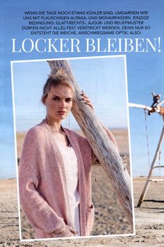 a woman standing next to a swing set in the sand and wearing a pink cardigan