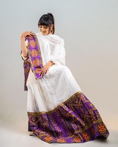 This full Shimena Kemis is a true celebration of Ethiopian culture and tradition. The dress is made with high-quality Menen fabric, which adds a touch of elegance and sophistication to the overall design. The dress features vibrant colors that are inspired by the Ethiopian landscape and culture. The dress is designed to fit comfortably and flatteringly, with a fitted bodice and a full skirt that flows beautifully as you move. The dress is complemented by carefully selected accessories, such as a White Ceremonial Dress With Zari Work, Ceremonial White Dress With Zari Work, Ceremonial White Dabka Dresses, Traditional Cutdana Dresses For Diwali, Bollywood Dress With Traditional Patterns For Ceremonies, Festive Floor-length Sets With Traditional Patterns, Traditional Cutdana Dress For Eid, Traditional Dress With Cutdana For Eid, Unstitched Anarkali Set For Traditional Ceremonies