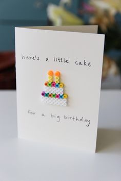 there is a little cake made out of legos on a card that says, here's a little cake for a big birthday