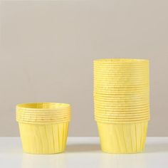 a stack of yellow cups sitting next to each other