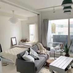 a living room filled with furniture next to a window