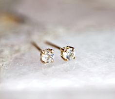 "14k yellow gold and white sapphire stud earrings. They will make a great companion to your beautiful wedding. They are very elegant for daily use or for official gatherings. SOLD AS PAIR. Available white gold or yellow gold from drop down menu. Material; 14k solid gold studs Round white sapphire 3mm Prong settings. 14k gold backings included. ------------------------------------ GIFT WRAPPING My regular package is organza gift pouches or small gift box for protection. If you would like special Delicate Yellow Gold Diamond Earrings As Gift, Minimalist Yellow Gold Diamond Earrings For Wedding, Delicate Diamond Earrings With Prong Setting As Gift, Delicate Diamond Earrings With Prong Setting, Delicate Single Diamond Earrings For Anniversary, Delicate Diamond Earrings With Single Diamond For Gift, Delicate Single Diamond Earrings As A Gift, Dainty Yellow Gold Diamond Earrings With Single Cut, Dainty Single Cut Diamond Earrings For Anniversary