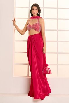 Hot pink padded, halter neck backless blouse with sequin hand embroidery. Comes with draped dhoti skirt and border embroidered dupatta style scarf. Paired with a matching tassel work potli bag. - Aza Fashions Elegant Pre-draped Saree With Tilla In Traditional Drape, Elegant Tilla Pre-draped Saree With Traditional Drape, Elegant Pre-draped Saree With Tilla Embroidery, Elegant Tilla Pre-draped Saree, Diwali Party Saree With Tilla Embroidery, Sleeveless Saree For Diwali Evening, Festive Georgette Choli With Side Open, Fitted Saree With Tilla Detailing, Reception Saree With Tilla Details