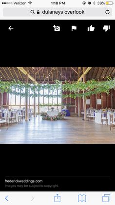 the inside of a building with tables and chairs set up for a wedding reception in it